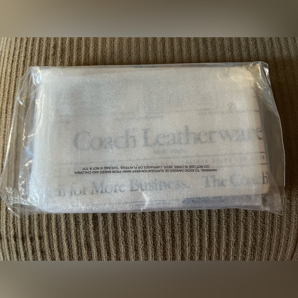 Coach Large Corner Zip Wristlet
With Newspaper Print NWT w/packaging - Picture 5 of 5